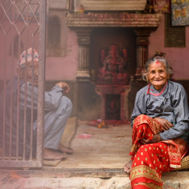 man and woman sitting in a home in Nepal