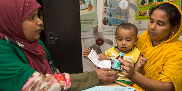 Mother receiving medicines with child